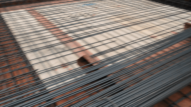 Construction worker arranging steel bars