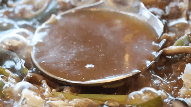 Hot pot broth scooped with a ladle