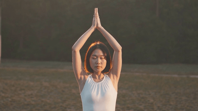 A woman practicing yoga outdoors