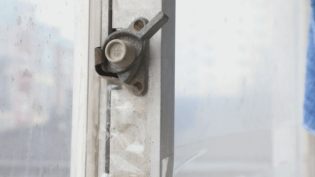 Close-up of a window latch indoors