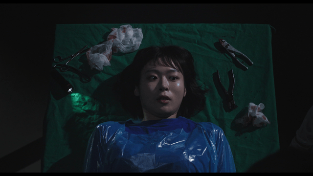 Woman lying on illegal operating table