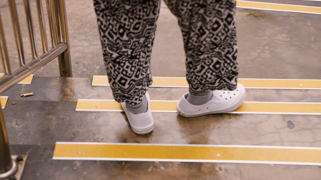 Person walking down wet stairs