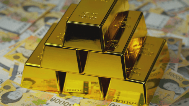 Gold bars stacked on Korean currency