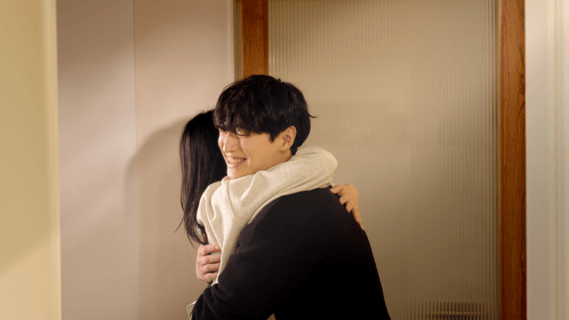 Couple embracing at the doorway