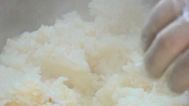 Mixing rice in a large bowl