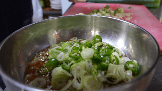 Metal bowl with scallion and chili seasoning sauce