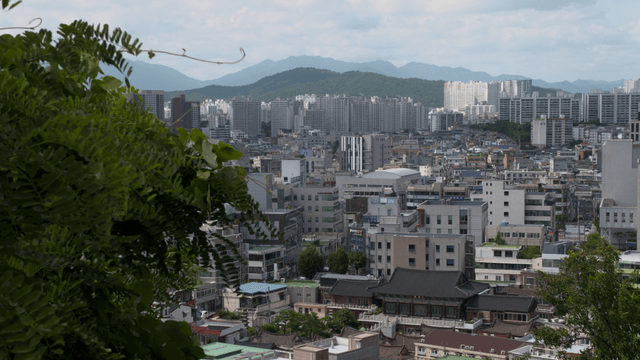 A cityscape with mountains in the background