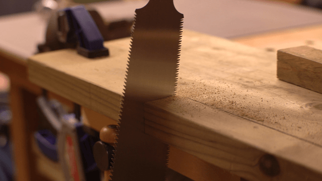 Wood being cut with a hand saw