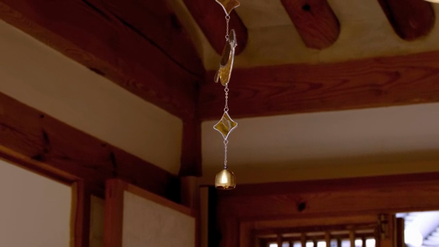 Bell hanging inside a traditional Korean building
