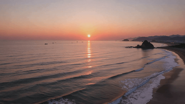Serene beach with waves at sunset