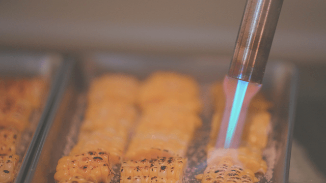 Grilled corn roasted with a torch