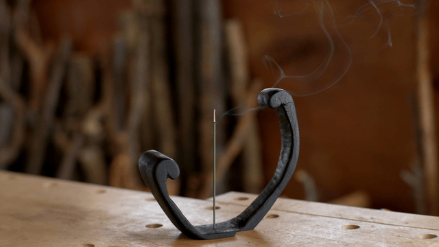 Burning incense on a unique wooden holder