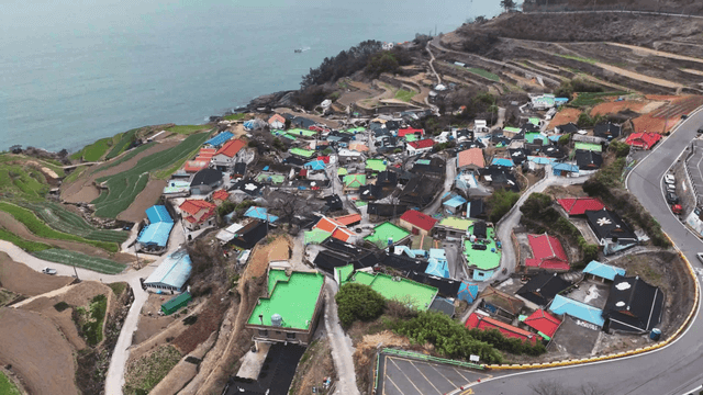 Terraced fields by the sea with a village
