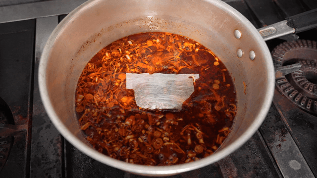 Teabag added to hot scallion chili oil pot