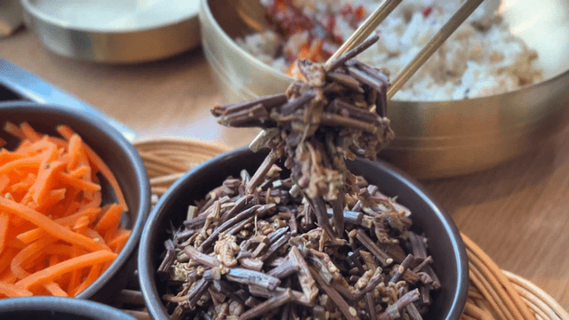 Chopsticks holding seasoned bracken