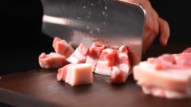 Diced pork on cutting board