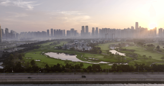City skyline with a park at sunrise