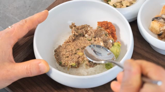 Mixing ingredients in a rice bowl