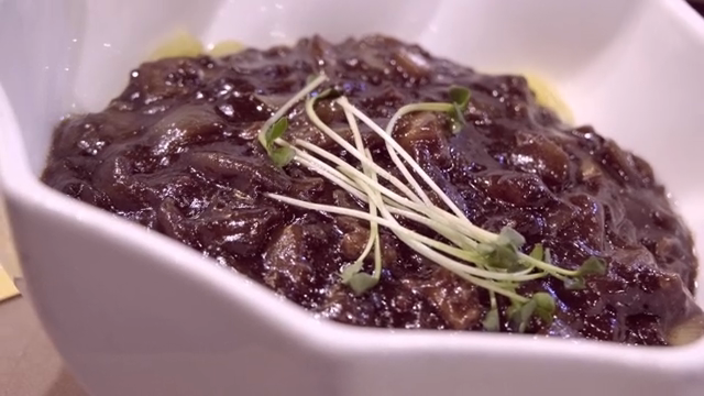 Noodles in Black Bean Sauce served in a white bowl