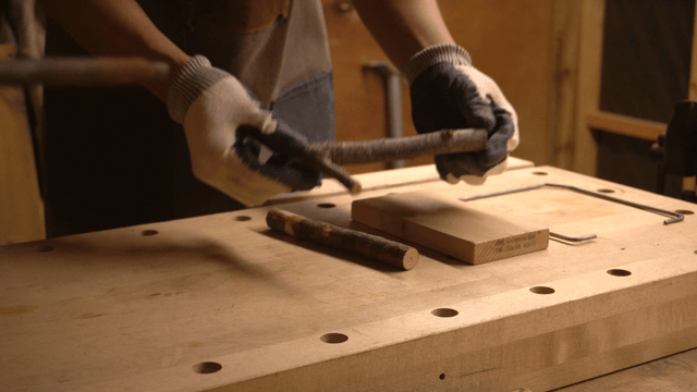 Woodcraft artisan arranging wooden materials in workshop