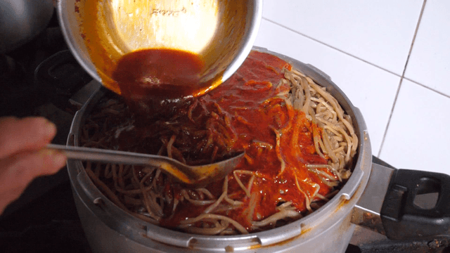 Boiled Sweet Potato Stems with Spicy Sauce Being Poured