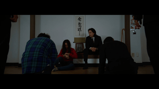 Tied woman and kneeling men in a traditional Japanese room