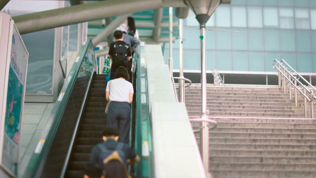 People using an escalator