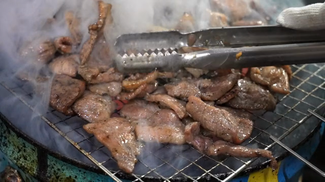 Grilled meat sizzling on a barbecue