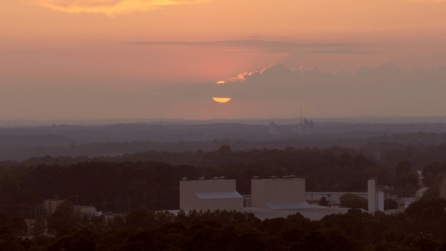 Sunset over a forested landscape