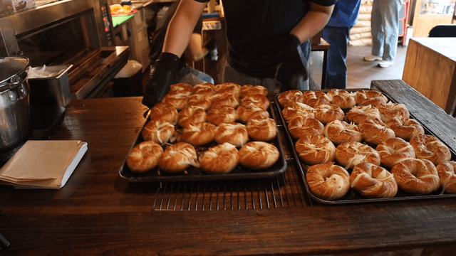 Baker preparing freshly baked bread in bakery