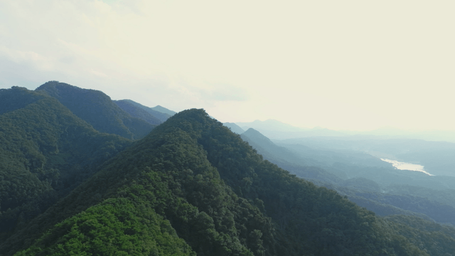 Lush green mountains under a bright sky