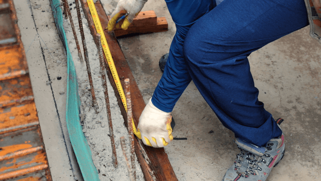 Worker measuring at a construction site