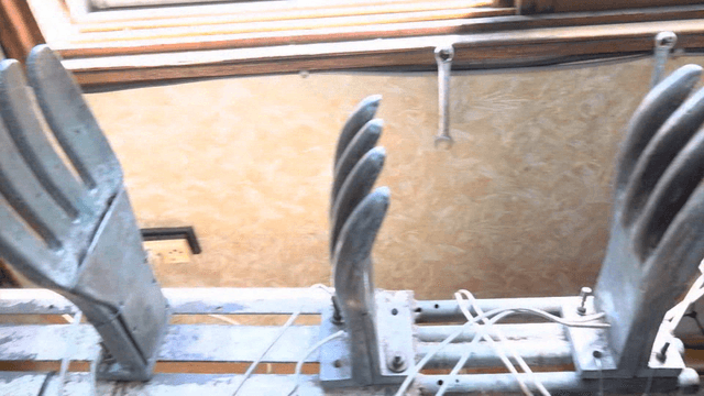 Glove-shaped metal molds and equipment in workshop