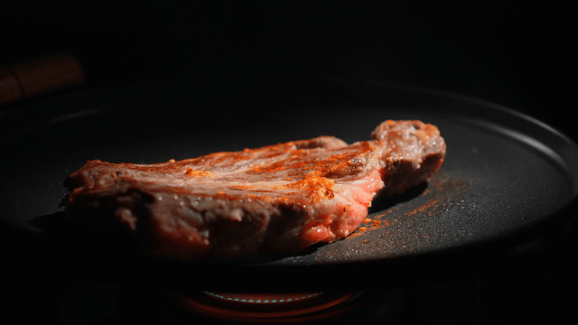 Steak being cooked on a hot grill