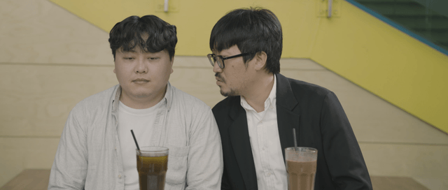 Two men having a conversation over drinks