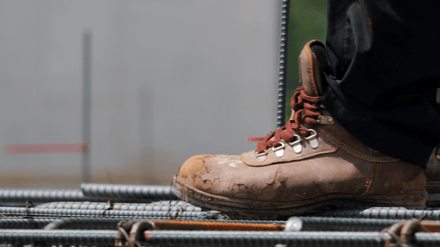 Worker tying rebar at a construction site