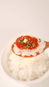Spoonful of rice with spicy red marinated crab