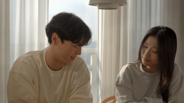 Couple smiling and talking by the window