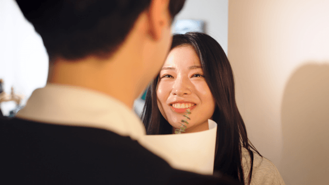 Couple happily receiving flowers at home