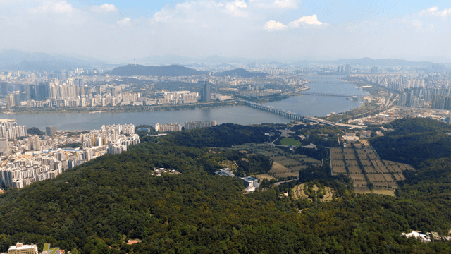 Expansive cityscape with river and greenery
