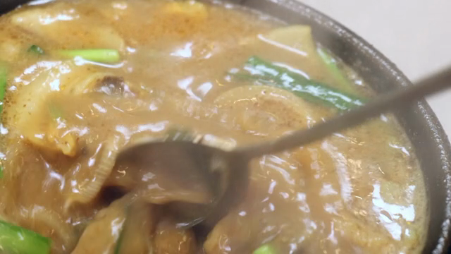 Sundae soup in a hot pot stirred with a spoon