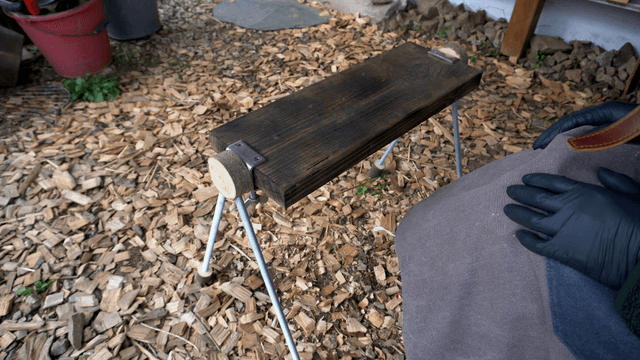 Woodcraft artisan touching a handmade wooden bench