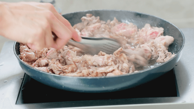 Meat being cooked in a pan