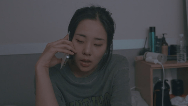 Woman talking on the phone in her bedroom