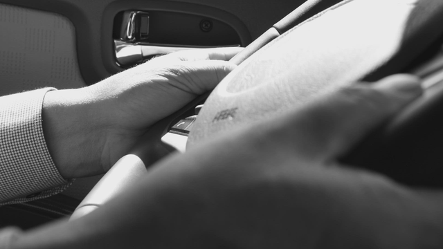 Hands gripping a steering wheel