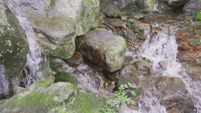 Small valley stream flowing between rocks
