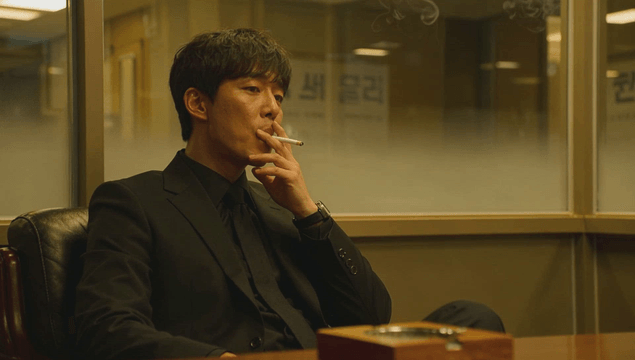 Businessman in a suit smoking in an office
