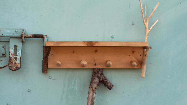 Wooden shelf attached to an iron door