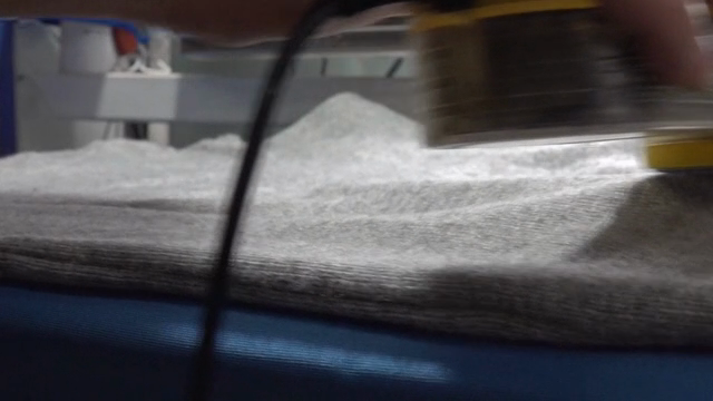 Removing lint from a gray sweater