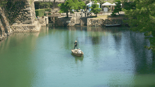 Two people on a boat in a serene river